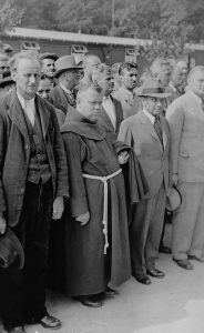 Newly arrived Czech prisoners still in their civilian clothes, as well as a Franciscan monk, stand at roll call in the Buchenwald concentration camp, Germany, 1939. Photo credit: USHMM #13131