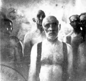 Jewish prisoners standing at the entrance to the gas chambers in Birkenau (Auschwitz II) at the Auschwitz-Birkenau extermination camp in Nazi-occupied Poland, date unknown. Photo credit: Yad Vashem #5318/234